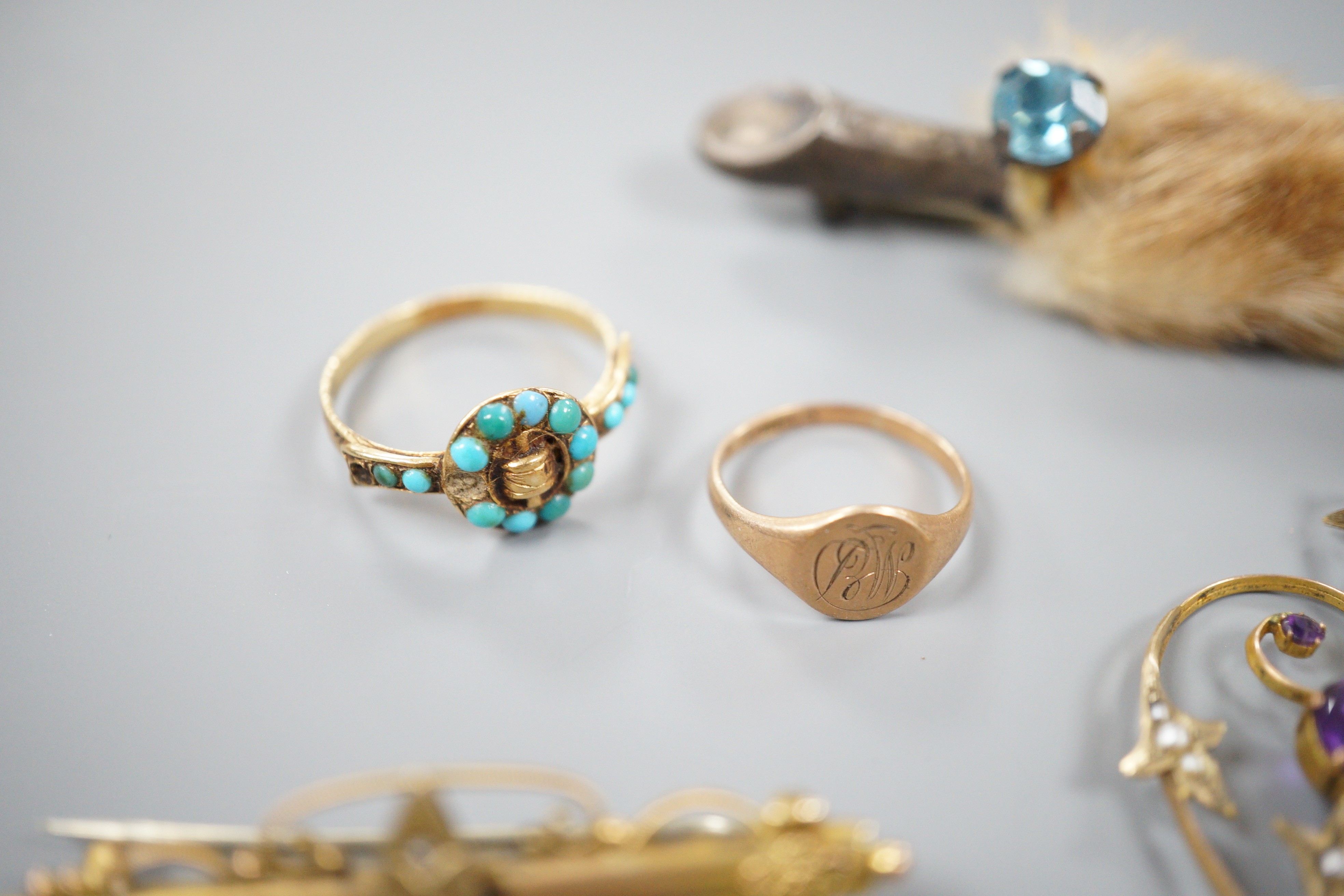 A small collection of jewellery to include an Edwardian amethyst and seed pearl pendant, two rings including Victorian yellow metal and turquoise 'buckle' ring, a bar brooch and a paw brooch.